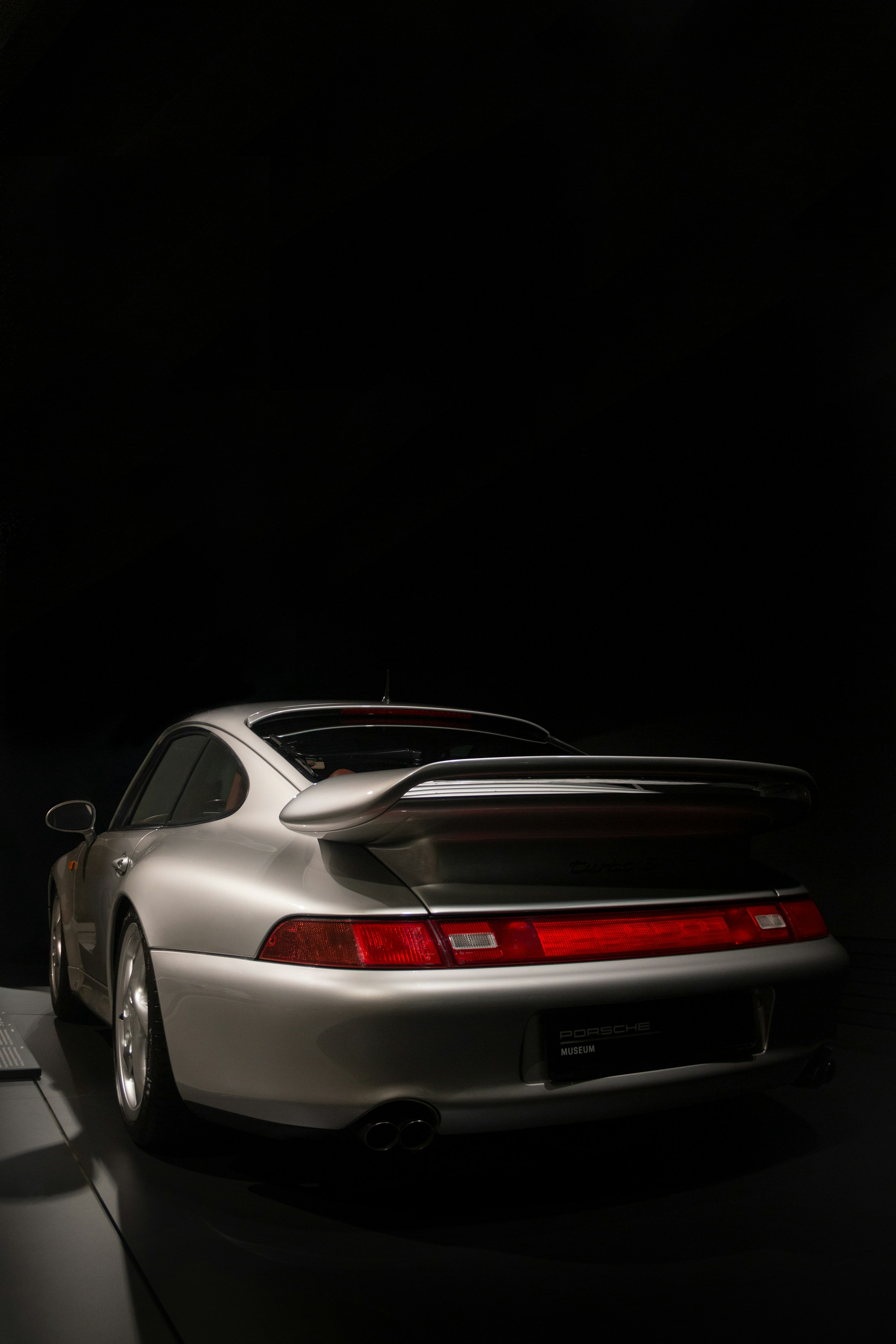 Rear three-quarter view of a silver Porsche 911, photographed by Florin Palamarciuc
